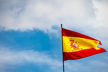 Spanish flag waving in a beautiful blue sky