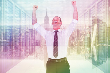 Poster - Handsome businessman cheering with arms up against server room with towers
