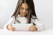 © kaganskaya115 - leisure, childhood, technology and people concept - child girl with tablet over grey background