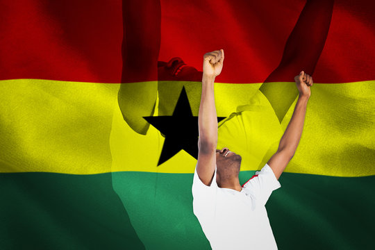 Excited handsome football fan cheering against digitally generated ghana national flag