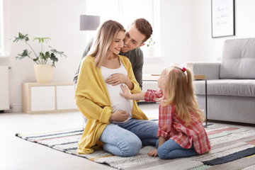 Wall Mural - Young pregnant woman with her family at home