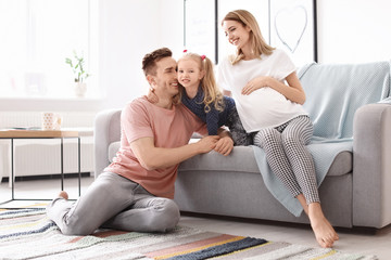 Poster - Young pregnant woman with her family at home