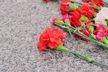 May 9 Russian Holiday Victory Day, End Of The World War II, With Day Of Glory. Red And White Carnations And Roses On A Gray Granite Slab. Cemetery Funeral Monument Concept
