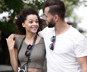 Poster - Cheerful young couple walking on urban street