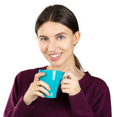 Canvas Print - Young woman holding a mug with a hot drink isolated on white background