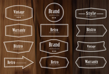 Aufkleber - Set of vector vintage style frame labels and elements for design, carve banner on wooden background.