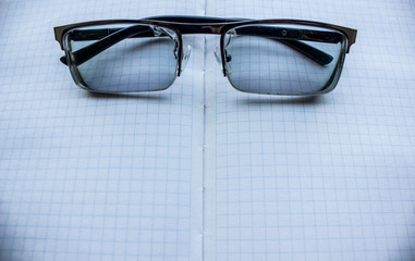 glasses on white paper notebook with space for copy or text