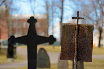 Cross on an old cemetery in springtime