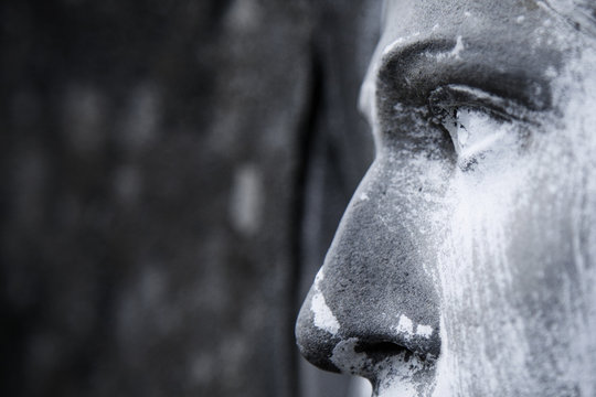 View in profile of an ancient statue of Mary Magdalene. Close up of sculpture. (religion, faith, holy, Christianity concept)