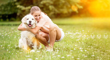 Woman Hugs Golden Retriever Dog