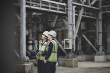 Industrial Workers Using A Digital Tablet On Site