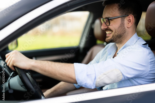 Portrait of a handsome businessman driving car - Buy this stock photo and explor