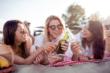 Sticker - Happy young women having fun on the beach,drinking beer