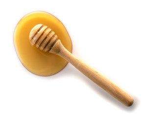 Wall Mural - honey with wooden honey dipper on white background
