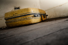 Suitcase On A Dirty Wooden Floor