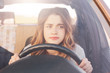 © sementsova321 - Nervous female driver sits at wheel, has worried expression as afraids to drive car by herself for first time. Frightened woman has car accident on road. People, driving, problems with transport