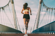 © DavidPrado - Young fit blonde woman running on the bridge