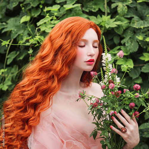 Beautiful pre-raphaelite girl with curly red hair with a flying tulle dress on t Poster