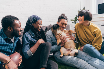 Wall Mural - group of smiling young multicultural friends with french bulldog