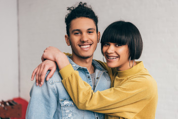 Wall Mural - portrait of young smiling mixed race couple