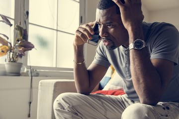 Black guy talking phone with angry emotion