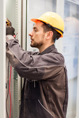 Wall Mural - electrician engineer tests electrical installations on relay protection system