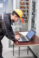 Wall Mural - field service engineer inspect relay protection system with laptop comput