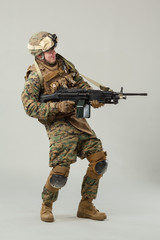 Wall Mural - Soldier in camouflage holding rifle