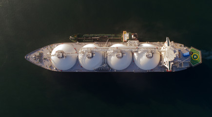 Wall Mural - A top view of a small tanker on a roadstead unloads a large LNG tanker.