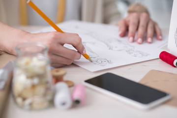 Wall Mural - Exceptional vision. Close up of female hands using pencil while painting sketch