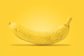 Ripe banana. Raw organic sweet banana on the yellow background. Bananas ready to eat.