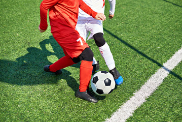 Wall Mural - Child soccer players and ball on football field