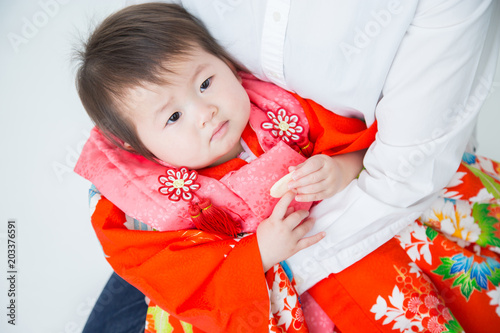 初節句で母親に抱かれる赤ちゃん 不機嫌 Stock Photo Adobe Stock