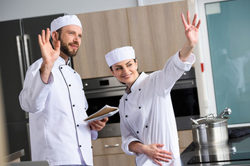 Canvas Print - chefs waving hands at restaurant kitchen