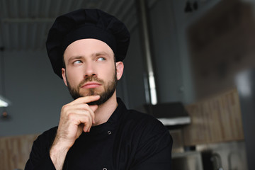 Canvas Print - portrait of pensive handsome chef at restaurant kitchen