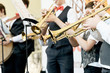 © SKfoto - Closeup of a group of children playing musical instruments.
