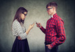 © Feodora - Couple using smartphones totally absorbed in online life, not talking to each other, facing one another.