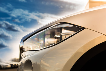 Canvas Print - luxury white car head lamp. sunlight