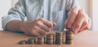 © Bits and Splits - Finances and budgeting, businessman stacking coins