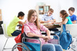 Teenage girl in wheelchair at school