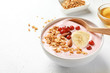 © New Africa - Bowl with delicious yogurt and granola on table