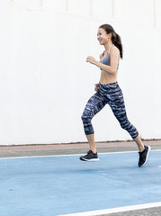 Wall Mural - White woman running on track