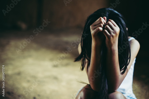 Fotomural Little sad girl hiding or locked in the basement
