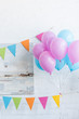 © LIGHTFIELD STUDIOS - bundle of pink and blue balloons in room, baby shower party concept