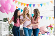 © LIGHTFIELD STUDIOS - multicultural women touching pregnant friend belly at baby-party