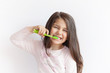 © kaganskaya115 - Little cute child girl brushing her teeth on white background. Space for text. Healthy teeth.