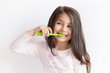 © kaganskaya115 - Little cute child girl brushing her teeth on white background. Space for text. Healthy teeth.