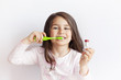 © kaganskaya115 - Little cute child girl brushing her teeth on white background. Space for text. Healthy teeth.