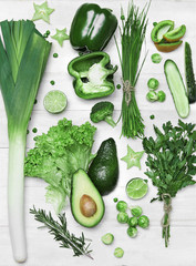 Wall Mural - Food Background. Green Vegetables And Fruits On Wooden Table