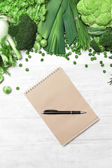 Canvas Print - Shopping List. Green Vegetables And Notebook On Table